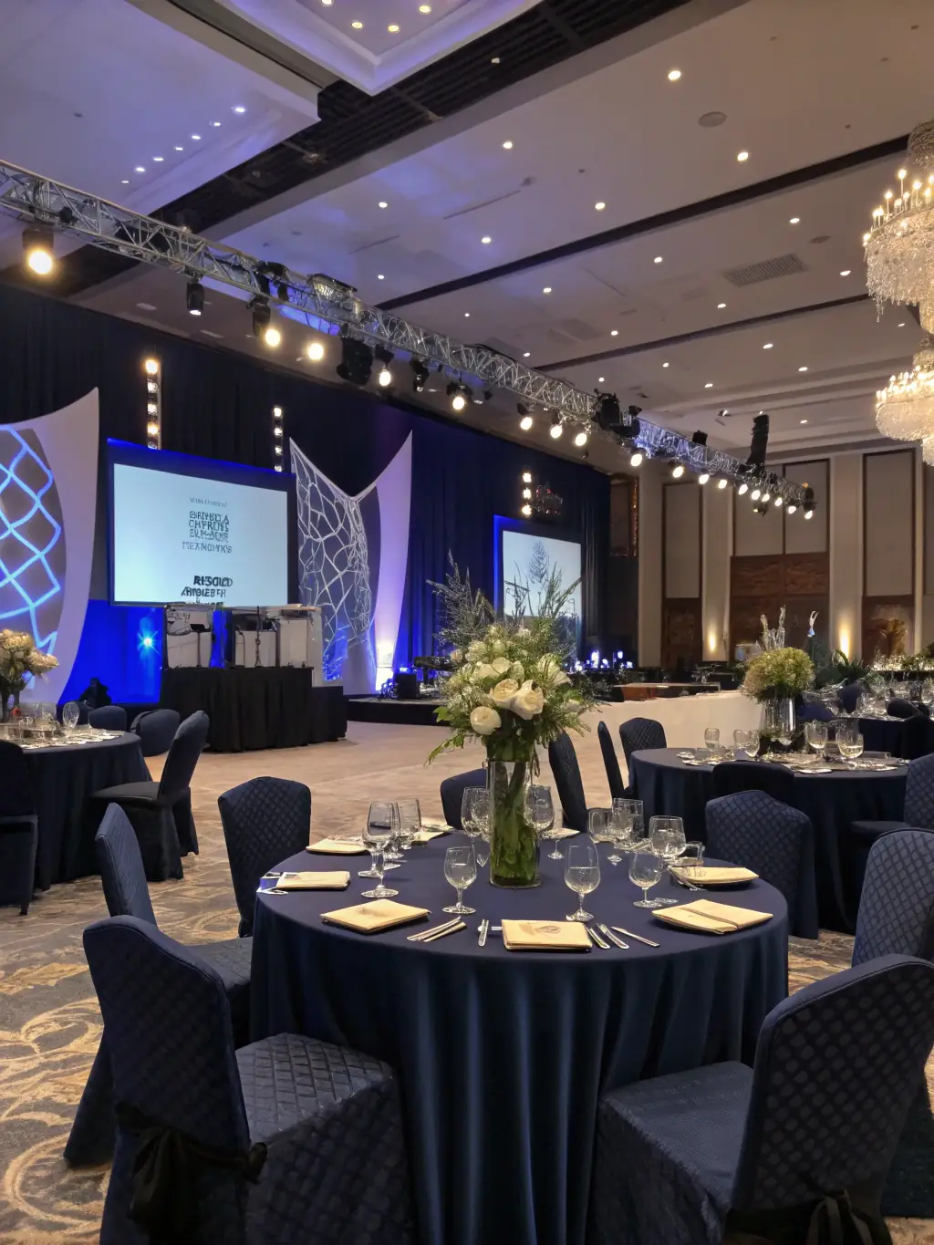 A sophisticated corporate event setup with elegant table settings and professional lighting, showcasing Oasis of Art's expertise in corporate event planning.